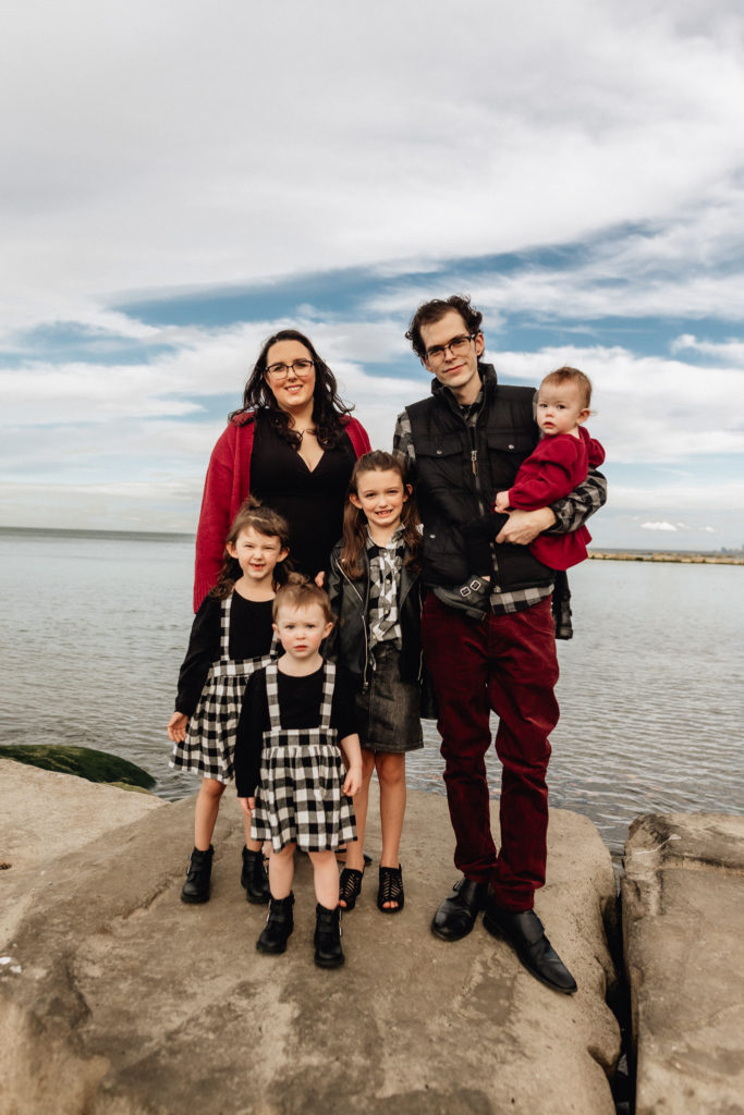 the whole family in coordinated outfits on the shore of lake erie 