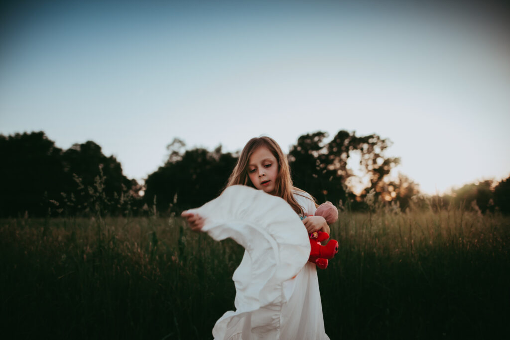 little girl throwing the hem of her white dress up