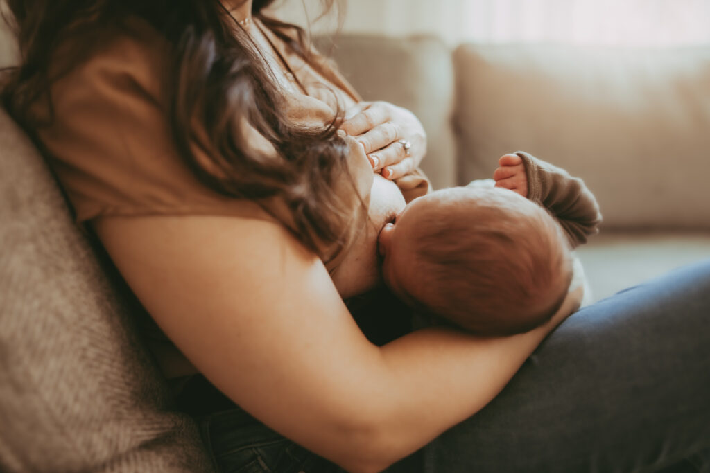 a close up of a mother breastfeeding her newborn baby in Cleveland Ohio