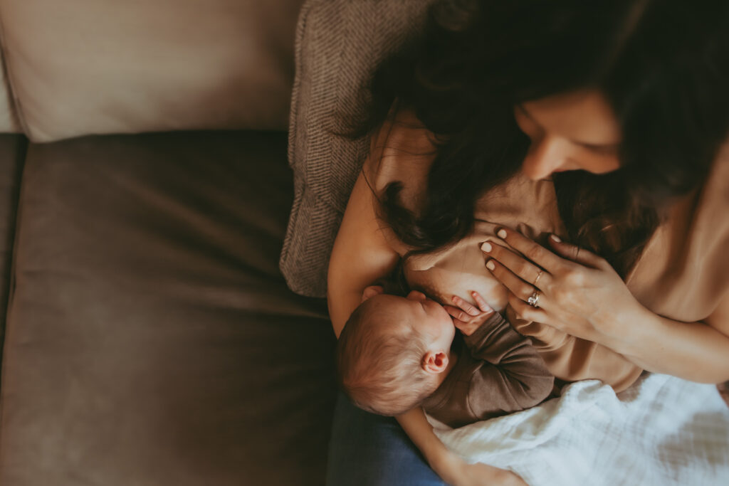 an off center image showing a mother breastfeeding her new baby in Cleveland ohio 