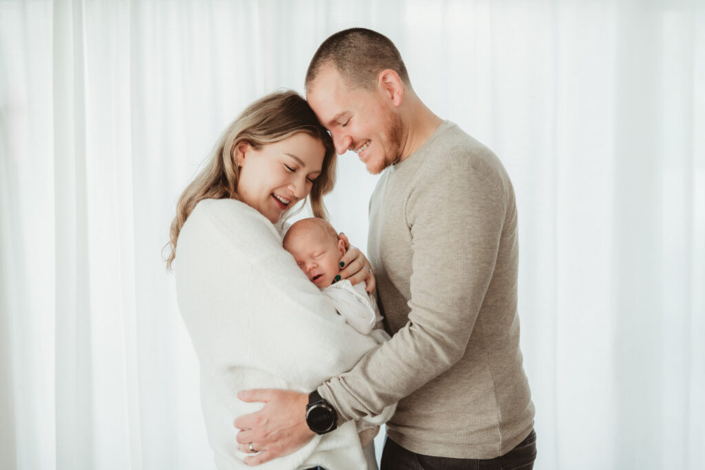 mom and dad soaking in the newborn snuggles