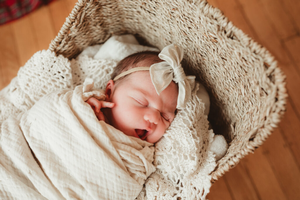 close up image of newborn in basket