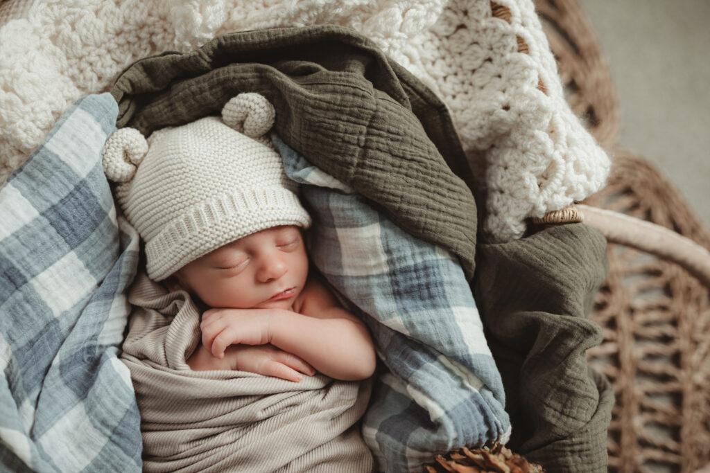 close up of baby face with knitted hat with bear ears.