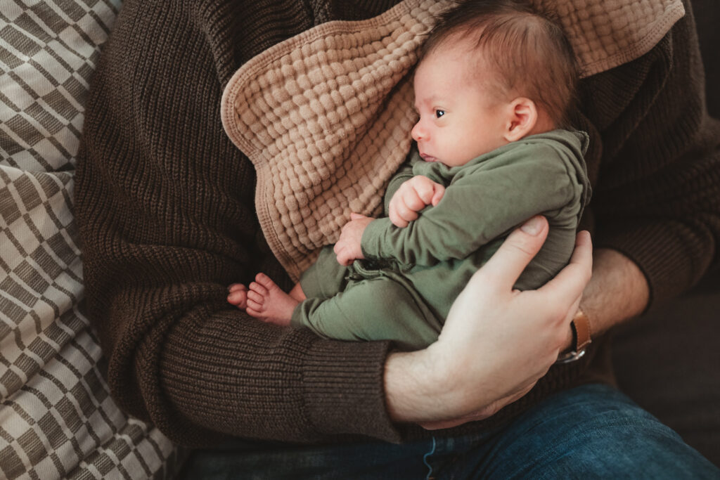 close up of newborn being held