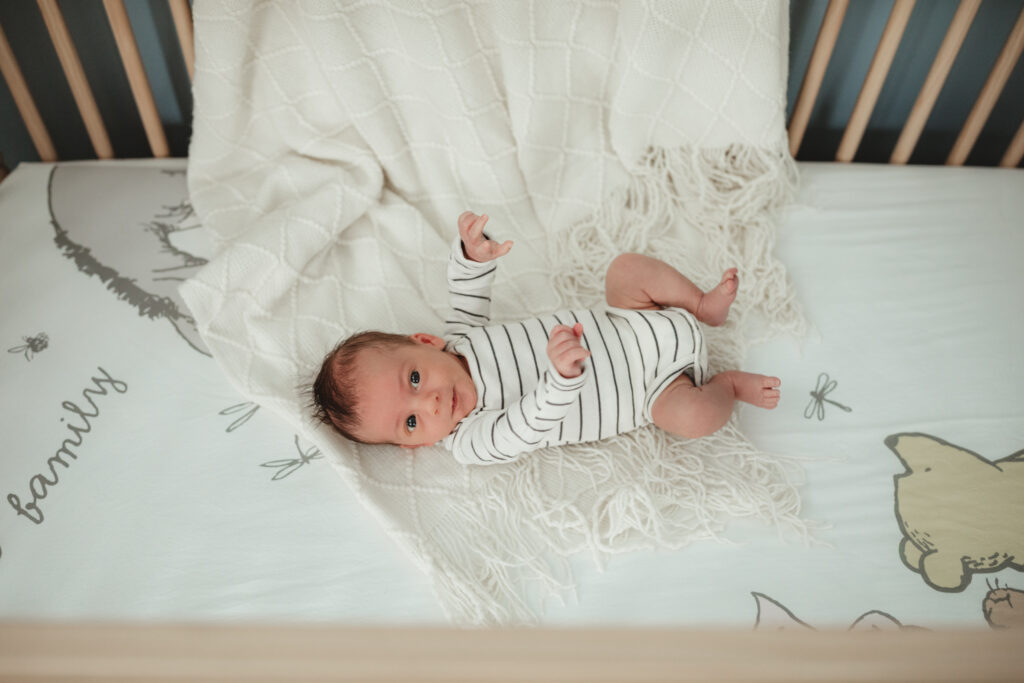 baby stretching out in his crib