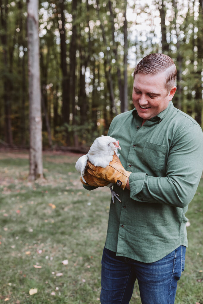 dad holds broody chicken