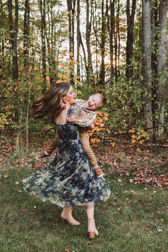 mom spinning her kiddo while he laughs
