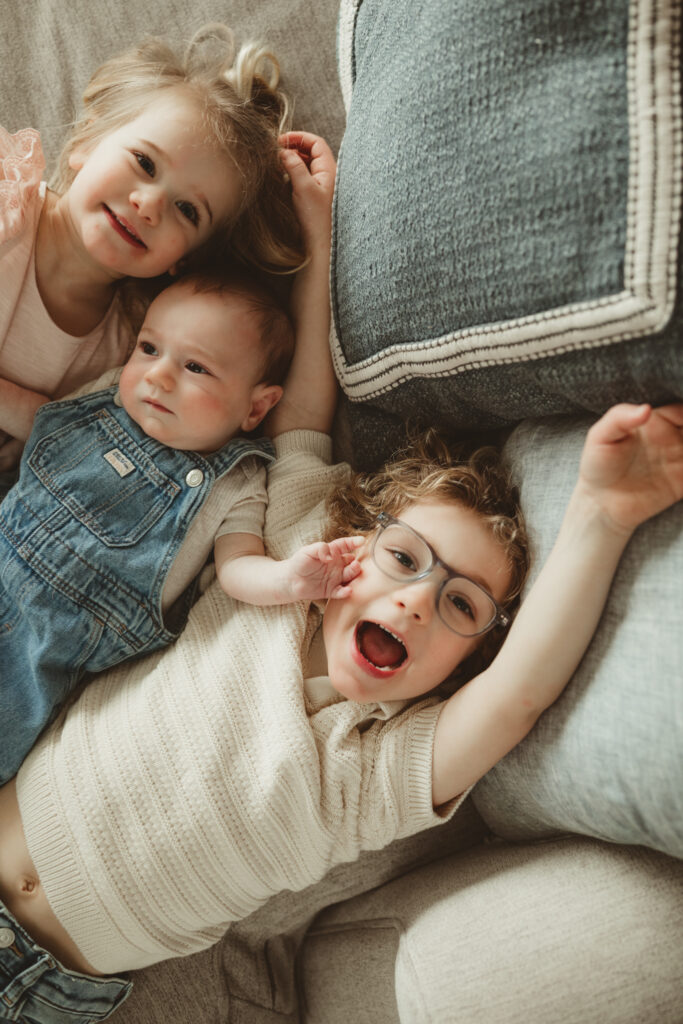 kids laying down looking at the camera