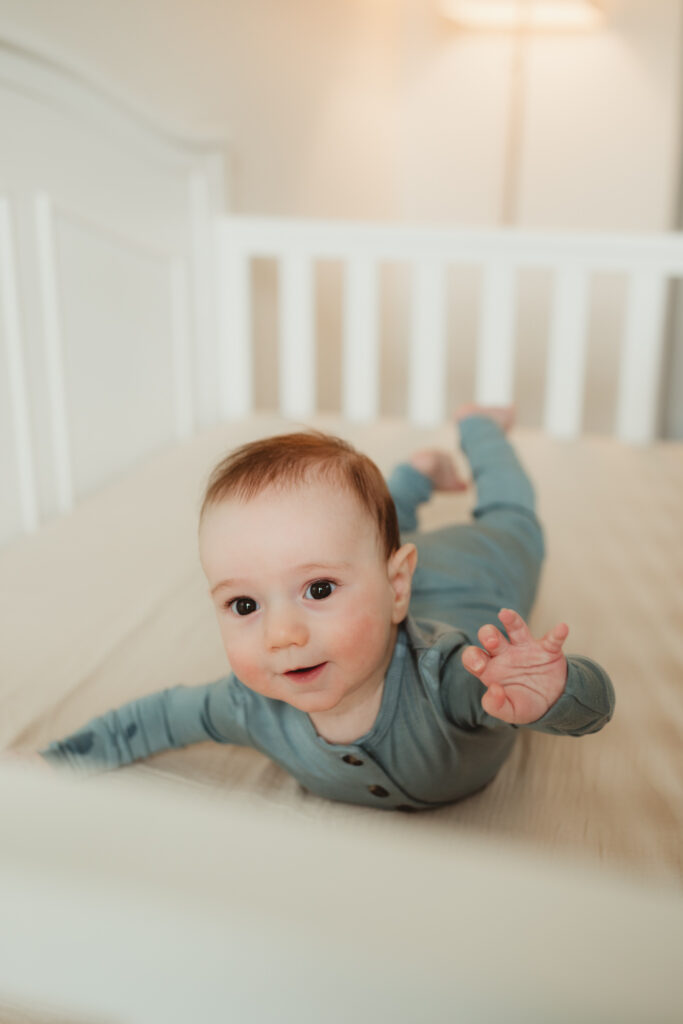 baby on his belly in his crib