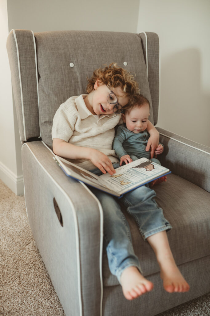 big brother reads book to baby