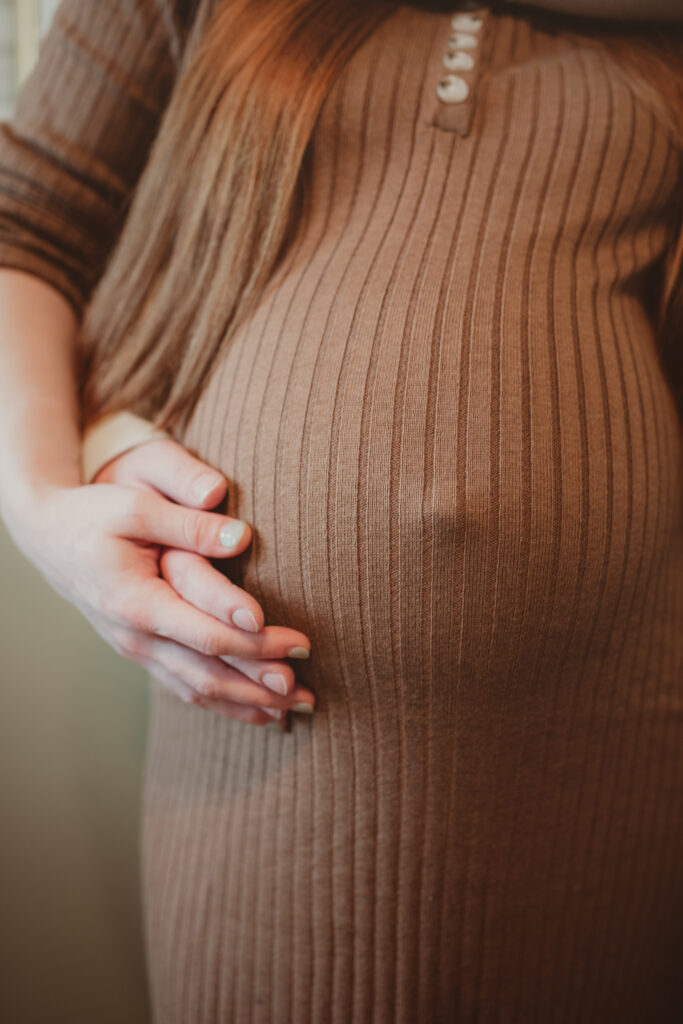 focus on the baby bump with mom and dads hands