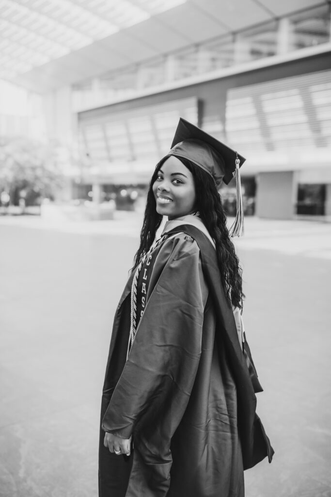 black and white of grad smiling at camera